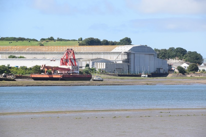 The Harland and Wolff shipyard at Appledore with hulked sailing ships north and south of the slipway
