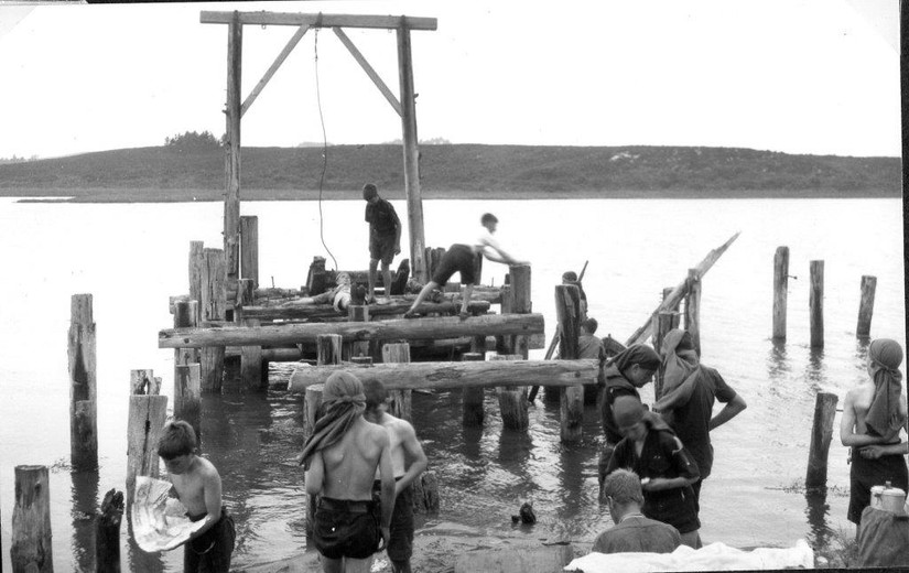 Children playing on the remains of the loading pier, Middlebere