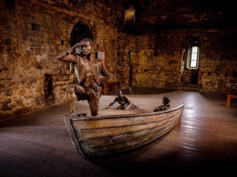 Sculpture of an African-Caribbean prisoner of war and his family in the keep at Portchester Castle