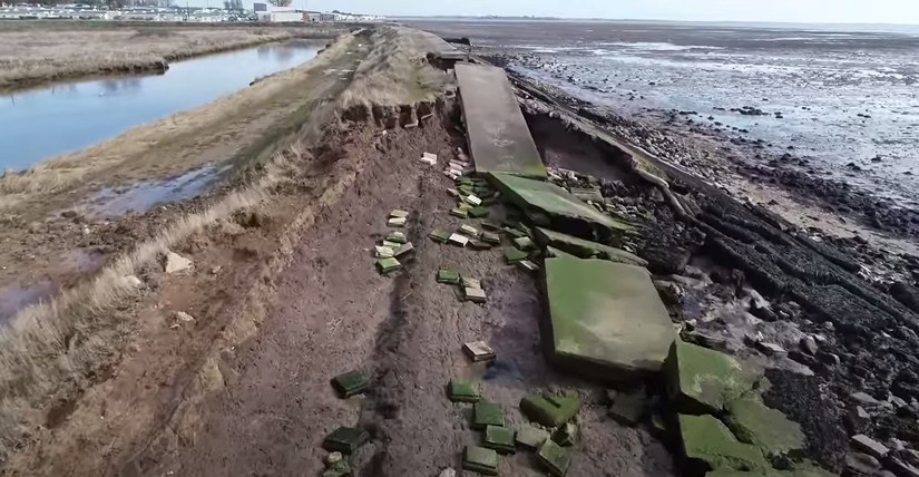 The modern seawall at Mersea Island is slowly being demolished by the sea, the land behind now lost for farming